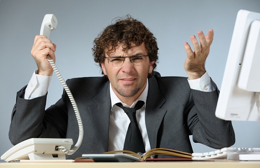 Man with phone looking frustrated